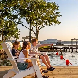 Guests relaxing in deck chairs on the dock at Little River Landing