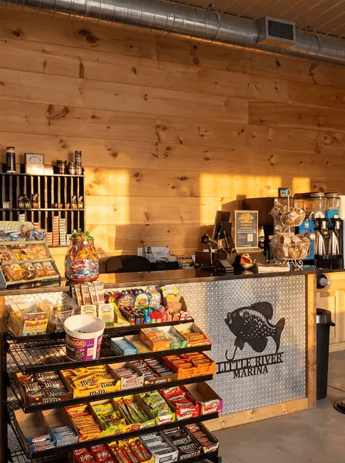 Snacks, candy and coffee along the counter inside the Little River Marina store